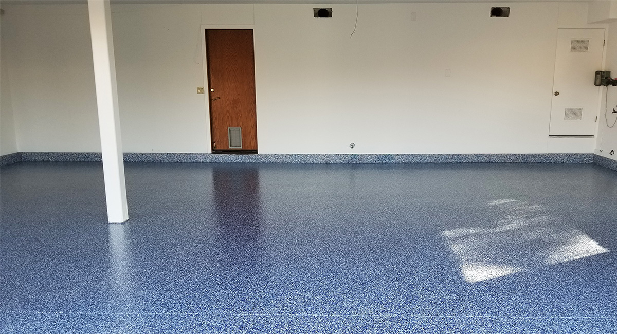 Interior view of garage with new blue-grey epoxy flooring set up by our Simi Valley garage floor contractors.