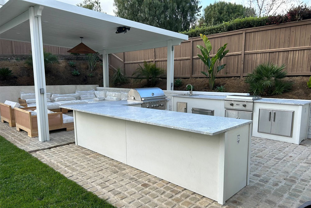 Outdoor kitchen with grill, sink, and counters, one of our Ventura exterior renovation projects.